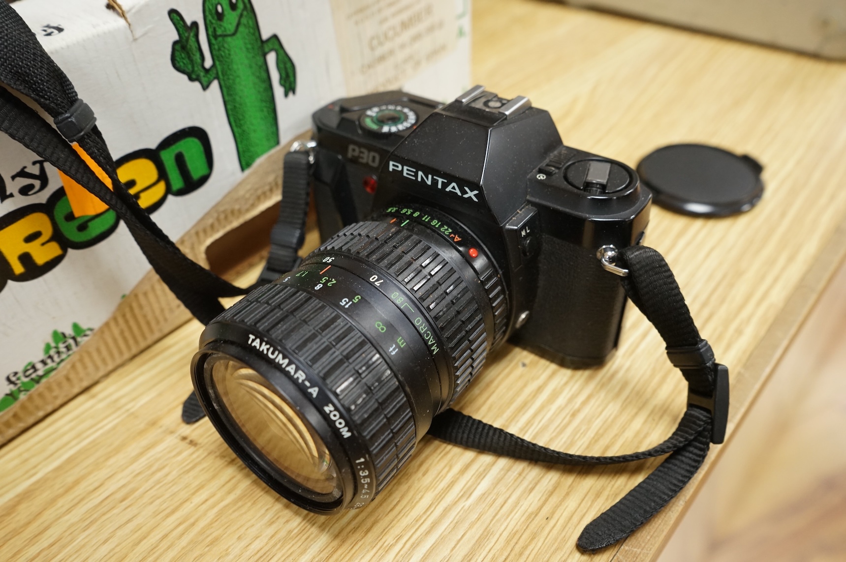 A Pentax P30 camera with Sunpak auto 2000DZ flash and instruction manual, together with an early 20th century mahogany cased quarter plate camera with accessories including lenses, a separate shutter unit, and four negat